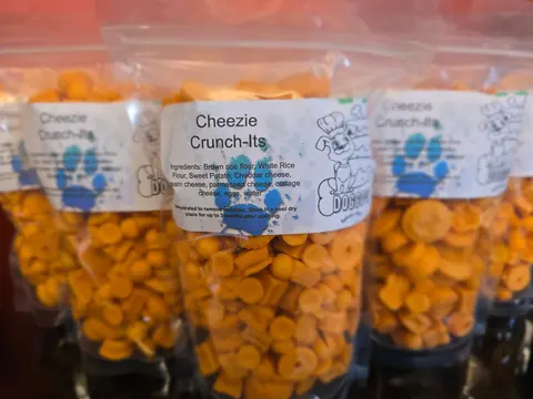 Bags of Cheezie Crunch-Its dog treats with paw-print labels
