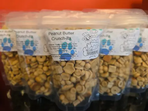 Bags of Peanut Butter Crunch-Its dog treats with paw-print labels